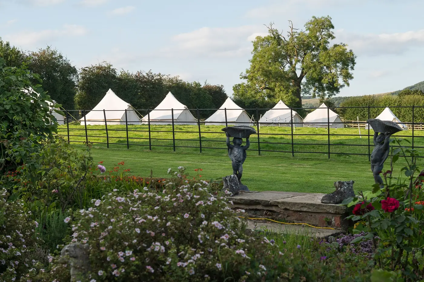 White bell tents put up by The Glamping Group