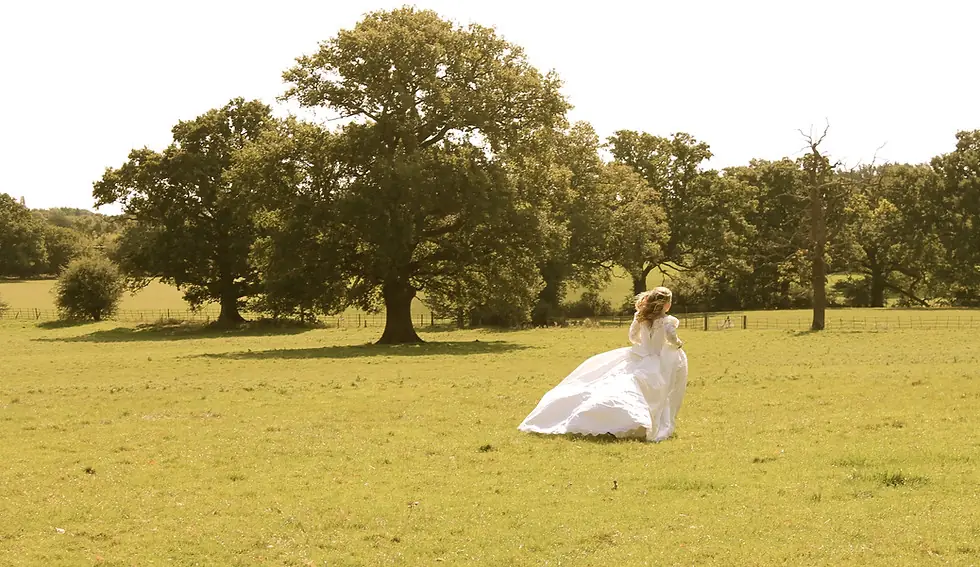 Bride celebrating wedding in Surrey field