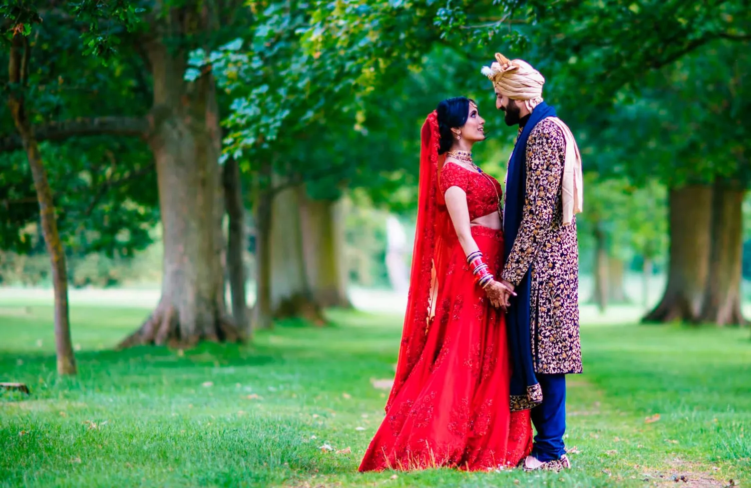 Wedding couple among trees at Stanford Hall