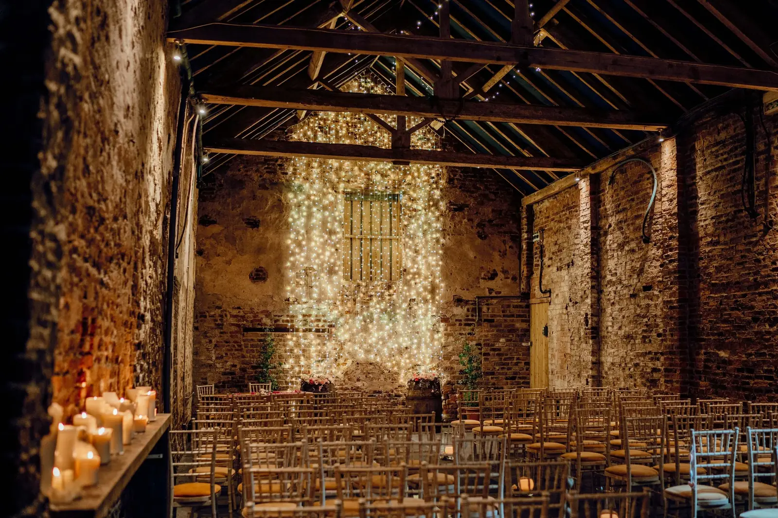The Normans wedding venue Ceremony Barn with beautiful twinkling fairy lights and original rustic features
