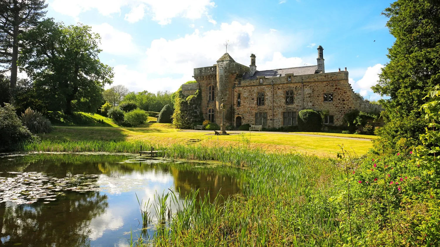 Tower house and lawn beside the lake