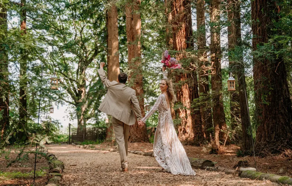 Wedding couple walking through the woodland at Two Woods Estate